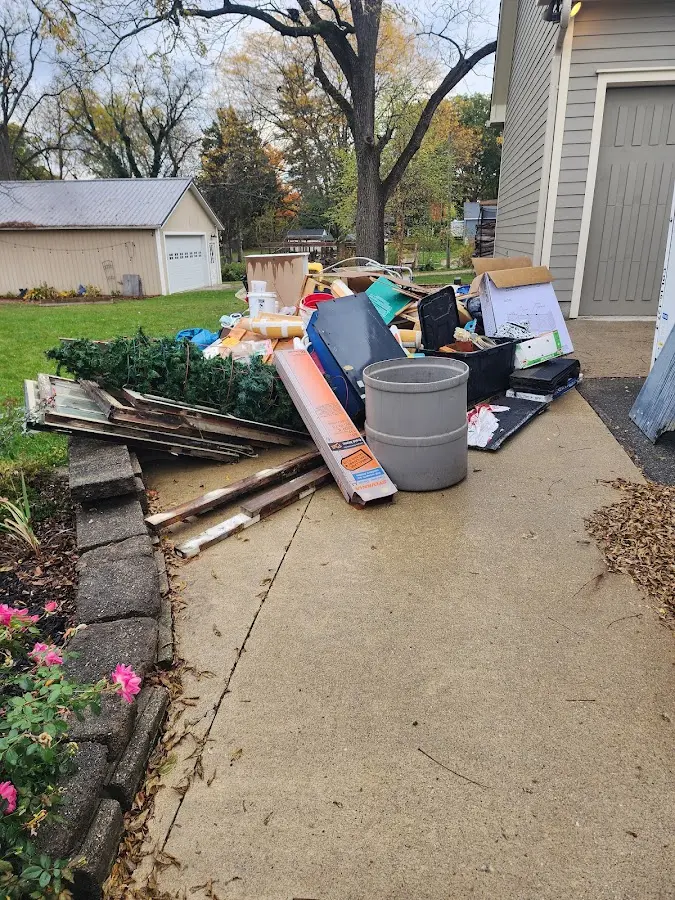 Dumpster being loaded with debris for 12 Yard Dumpster Rental in Malone